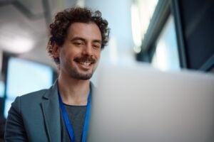 Happy businessman working on a computer board room.